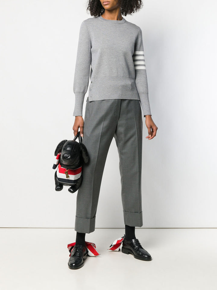 Thom Browne Classic Backstrap Trouser in medium grey wool with high waist, pressed creases, and wide turn-up cuffs, flat lay on white background