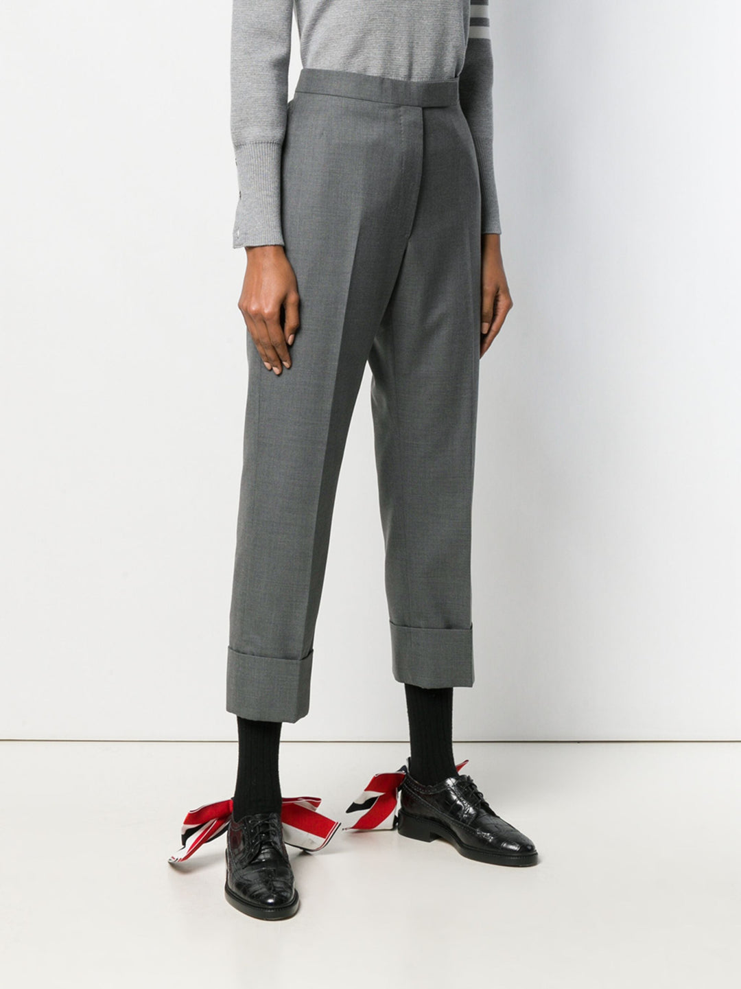 Thom Browne Classic Backstrap Trouser in medium grey wool with high waist, pressed creases, and wide turn-up cuffs, flat lay on white background