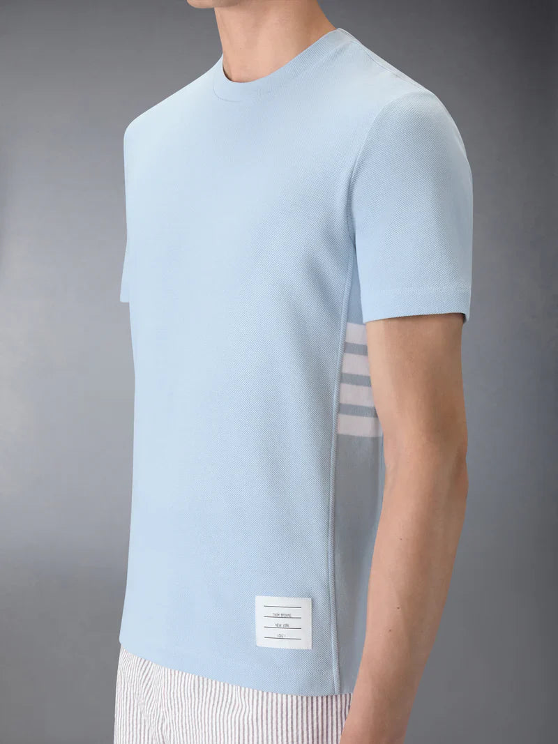 Thom Browne Classic Piqué 4-Bar Tee in light blue with signature stripe collar and woven hem label, front view