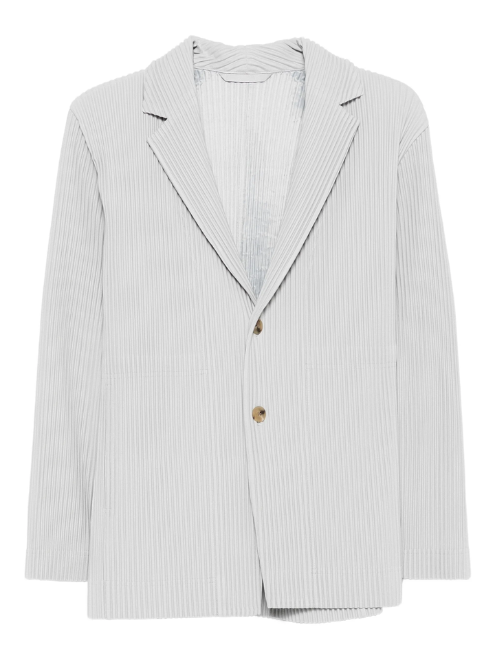 Homme Plissé Issey Miyake light grey pleated two-button jacket with notch lapels and gold-tone buttons, laid flat on white background
