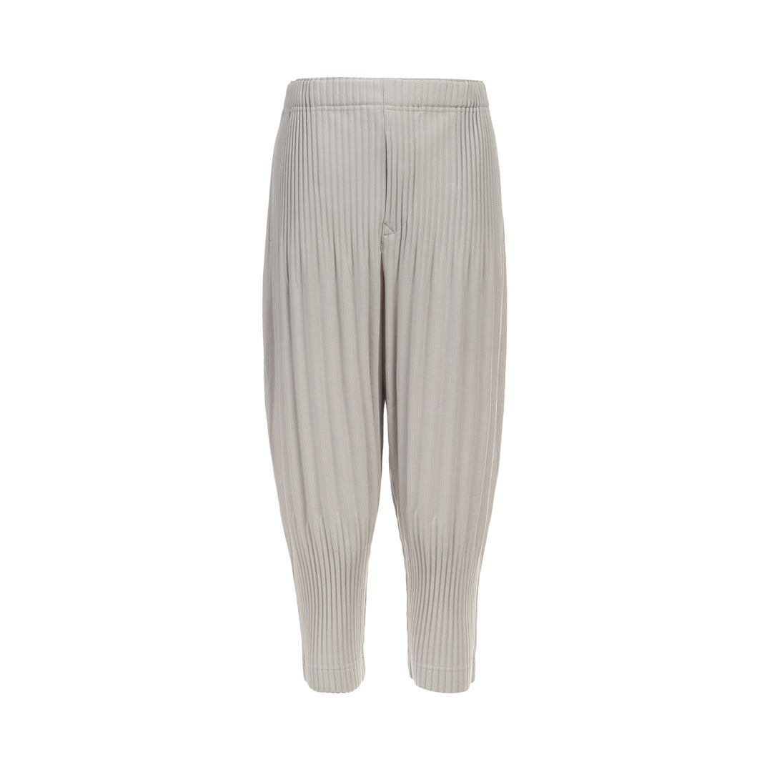 Homme Plissé Issey Miyake Basic Fluffy Long Pants in light grey, featuring signature all-over pleating, a relaxed balloon-tapered silhouette, elasticated waistband, and ribbed ankle cuffs