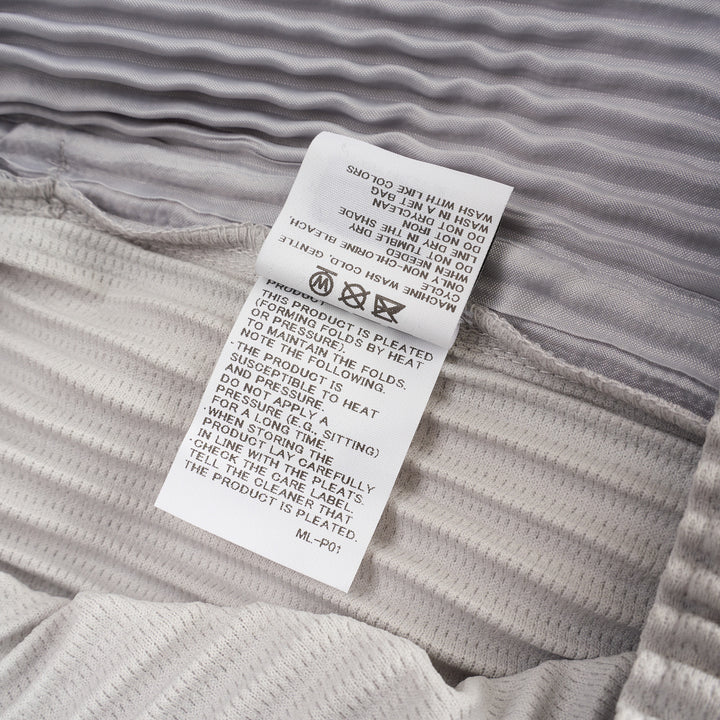 Homme Plissé Issey Miyake Basic Fluffy Long Pants in light grey, featuring signature all-over pleating, a relaxed balloon-tapered silhouette, elasticated waistband, and ribbed ankle cuffs - view 5