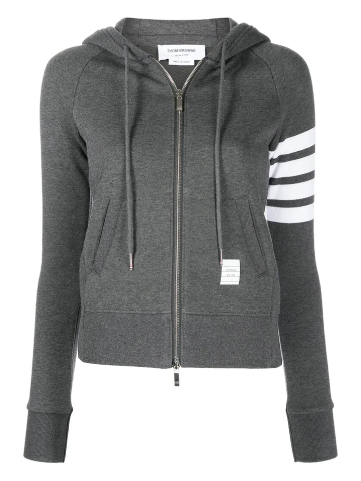 Thom Browne grey marl zip-up hoodie with four-bar white and grey stripe detail on the upper sleeve, full silver zip, drawstring hood, and front kangaroo pockets