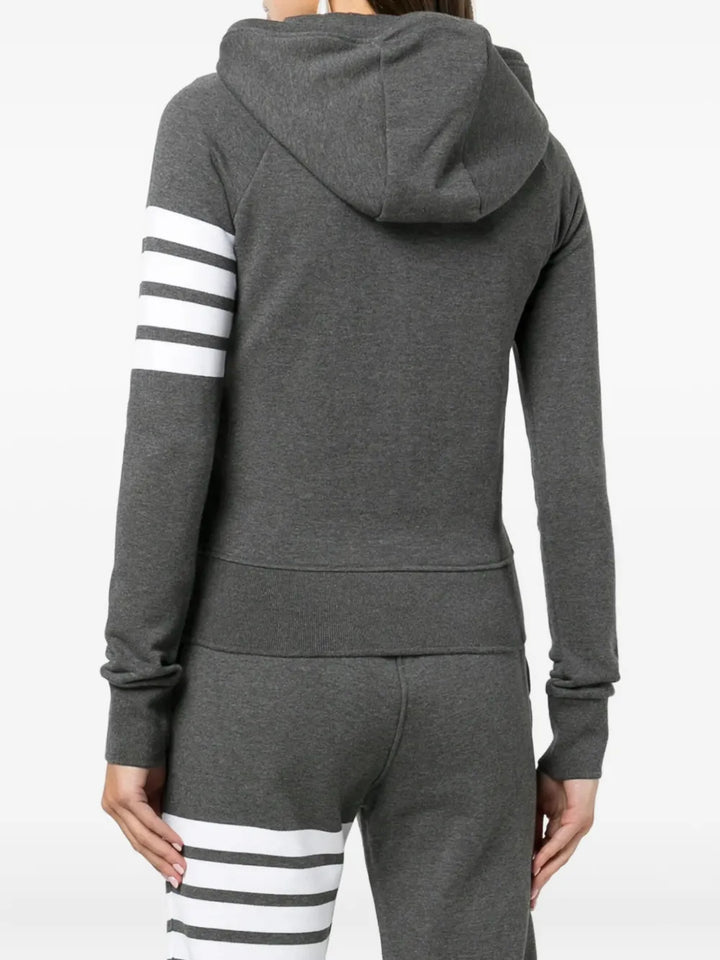Thom Browne grey marl zip-up hoodie with four-bar white and grey stripe detail on the upper sleeve, full silver zip, drawstring hood, and front kangaroo pockets