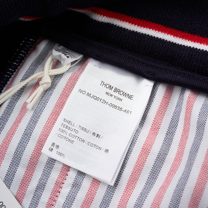 Thom Browne navy cotton sweat shorts with drawstring waist, white 4-Bar stripe on one leg and woven label patch at the hem - view 3