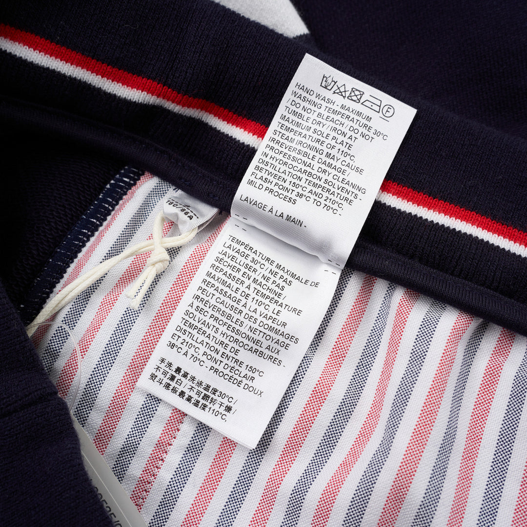 Thom Browne navy cotton sweat shorts with drawstring waist, white 4-Bar stripe on one leg and woven label patch at the hem - view 4