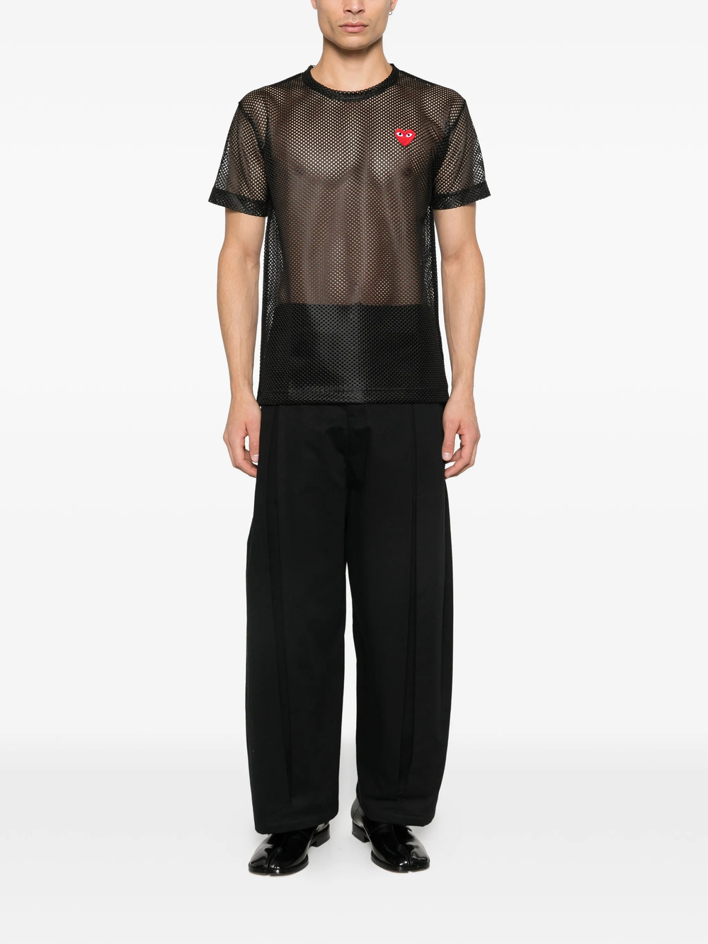 Comme des Garçons PLAY black open-weave mesh T-shirt with red heart emblem embroidered at the chest, laid flat on white background