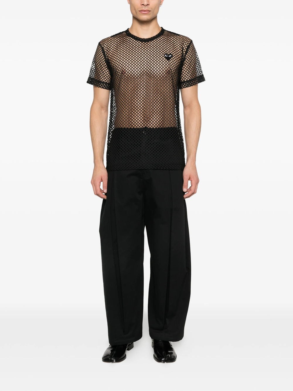 Comme des Garçons PLAY black open-knit mesh T-shirt with heart emblem patch on chest, crew neck, short sleeves, flat lay on white background
