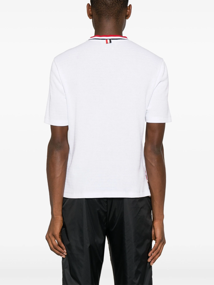 Thom Browne white short sleeve racking stitch crewneck tee with red, white, and navy stripe collar and chest pocket trim