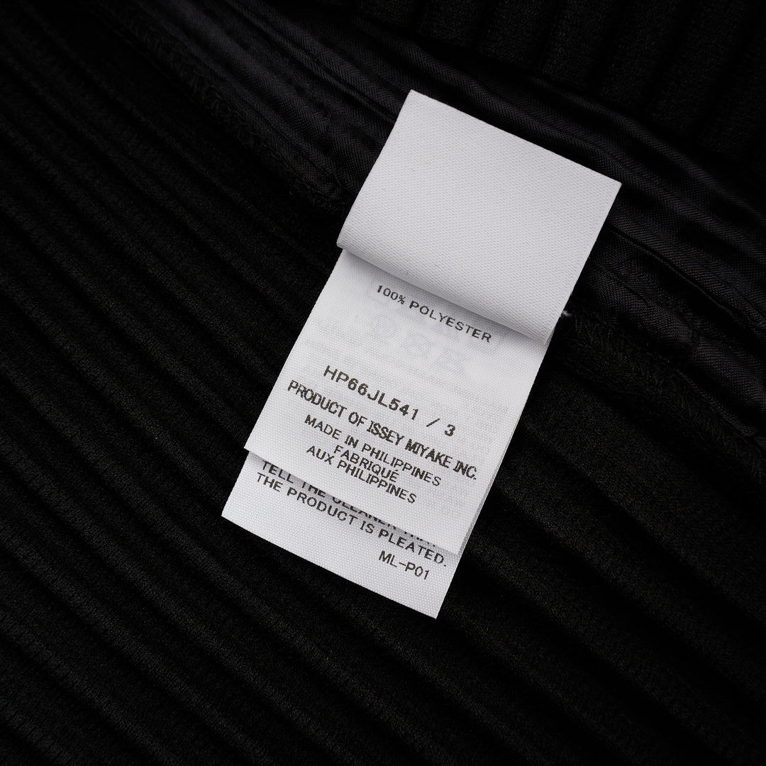 Homme Plissé Issey Miyake Basic Button Cardigan in black, featuring signature permanent accordion pleating across the body and long sleeves, with a deep V-neckline and four snap-button front closure - view 3