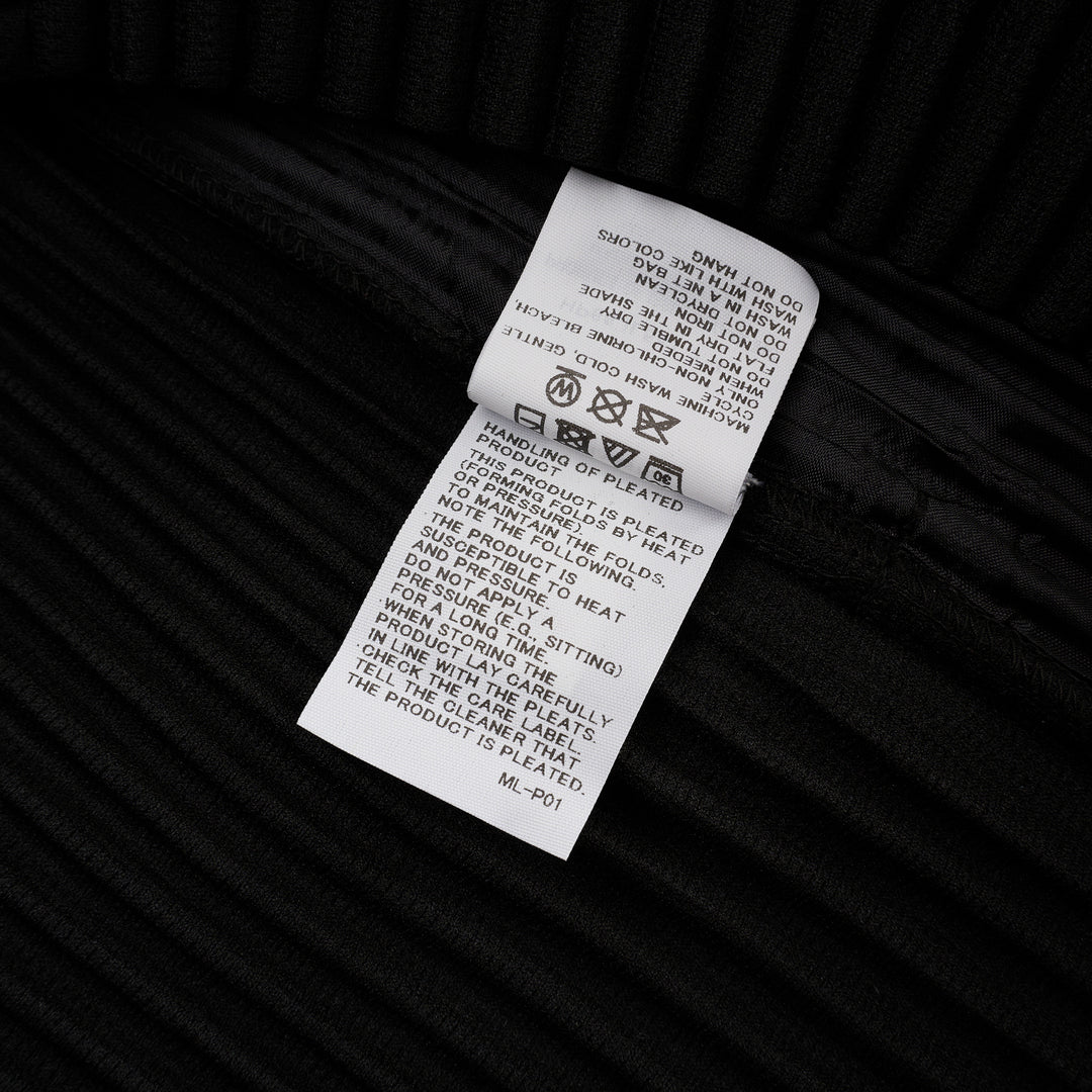 Homme Plissé Issey Miyake Basic Button Cardigan in black, featuring signature permanent accordion pleating across the body and long sleeves, with a deep V-neckline and four snap-button front closure - view 4