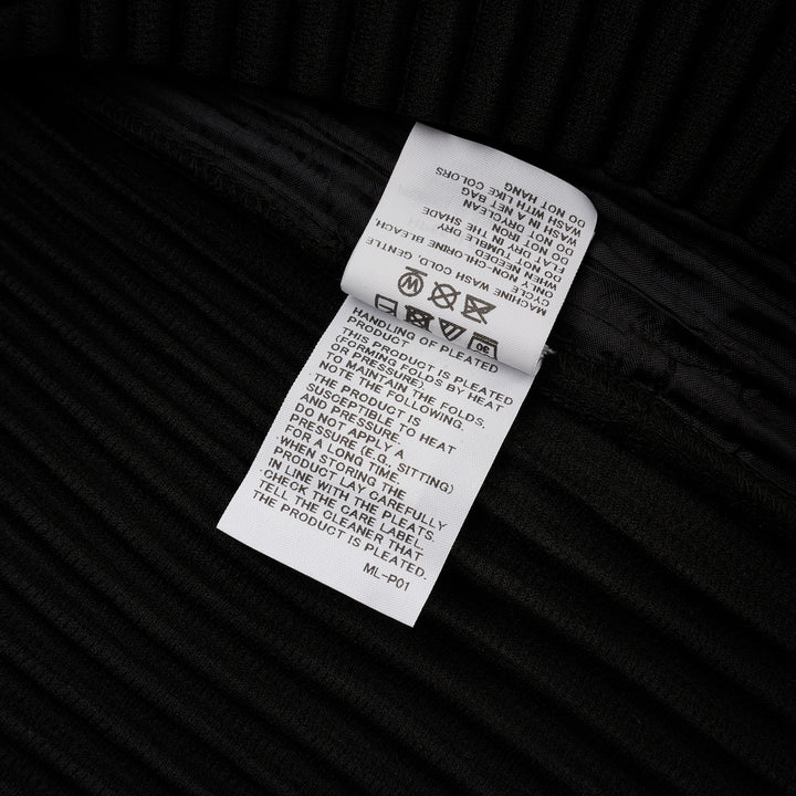Homme Plissé Issey Miyake Basic Button Cardigan in black, featuring signature permanent accordion pleating across the body and long sleeves, with a deep V-neckline and four snap-button front closure - view 4