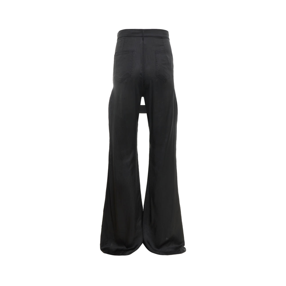 Rick Owens black flare pants with diagonal cross-body strap panel cut-out construction at the hip, high-rise waistband with silver button, and wide floor-length flared leg, photographed flat on a white background