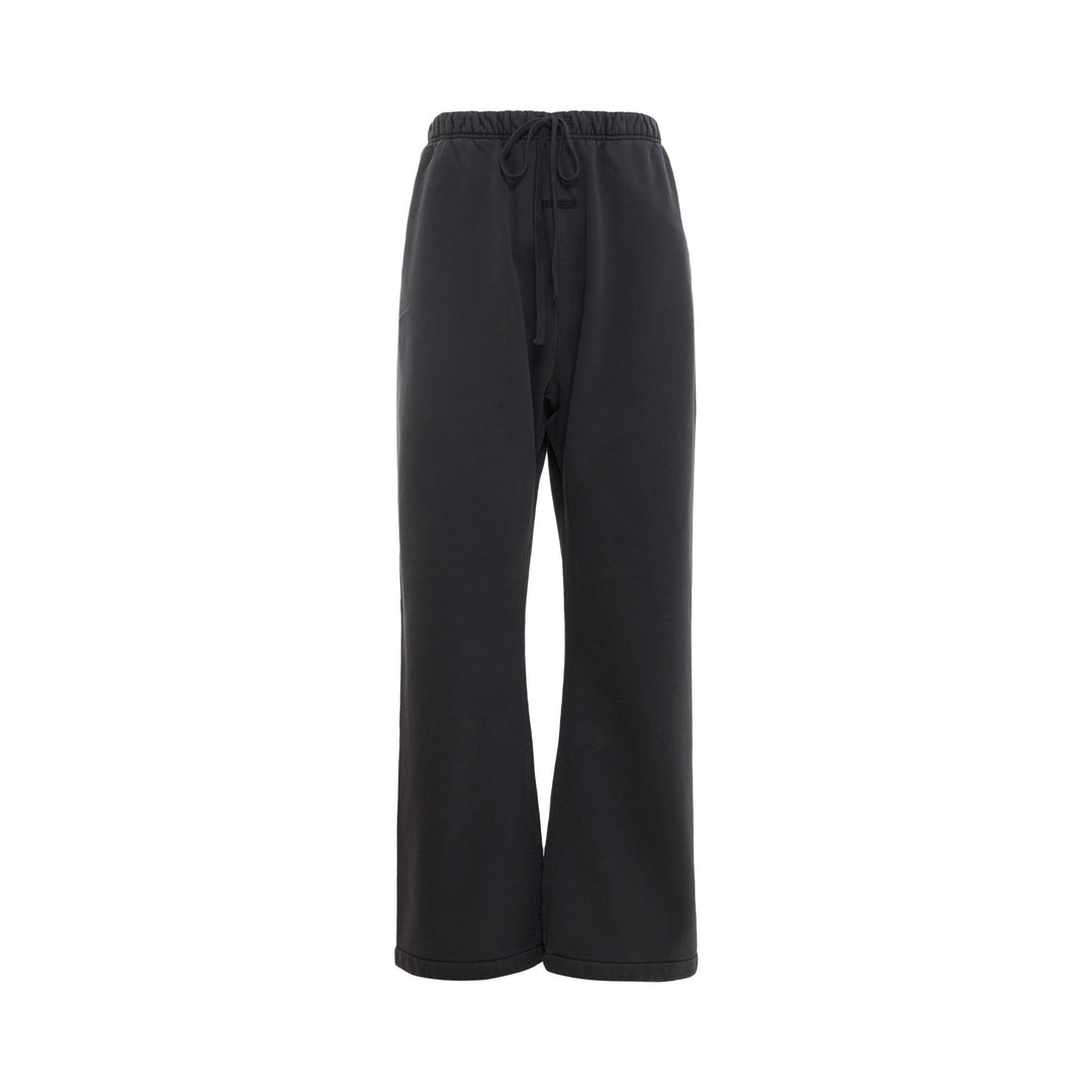 Fear of God Essentials Signature Flare Sweatpant in washed black with elastic drawstring waistband and wide flare leg
