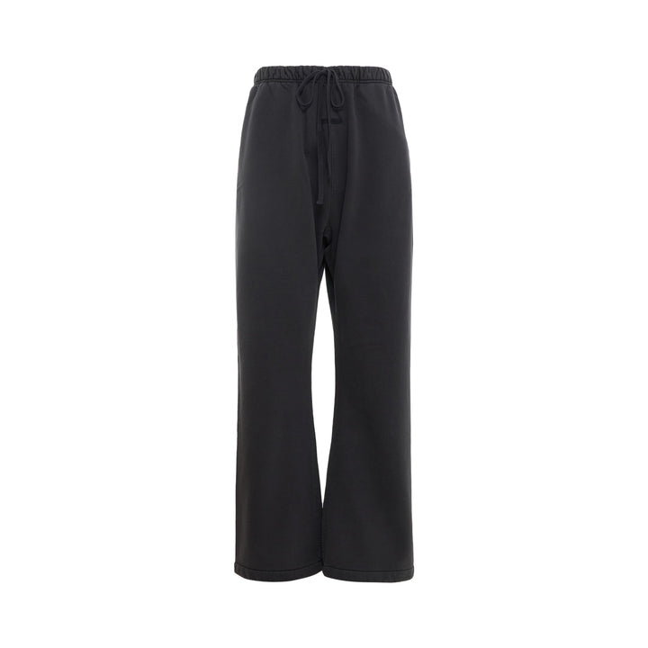 Fear of God Essentials Signature Flare Sweatpant in washed black with elastic drawstring waistband and wide flare leg