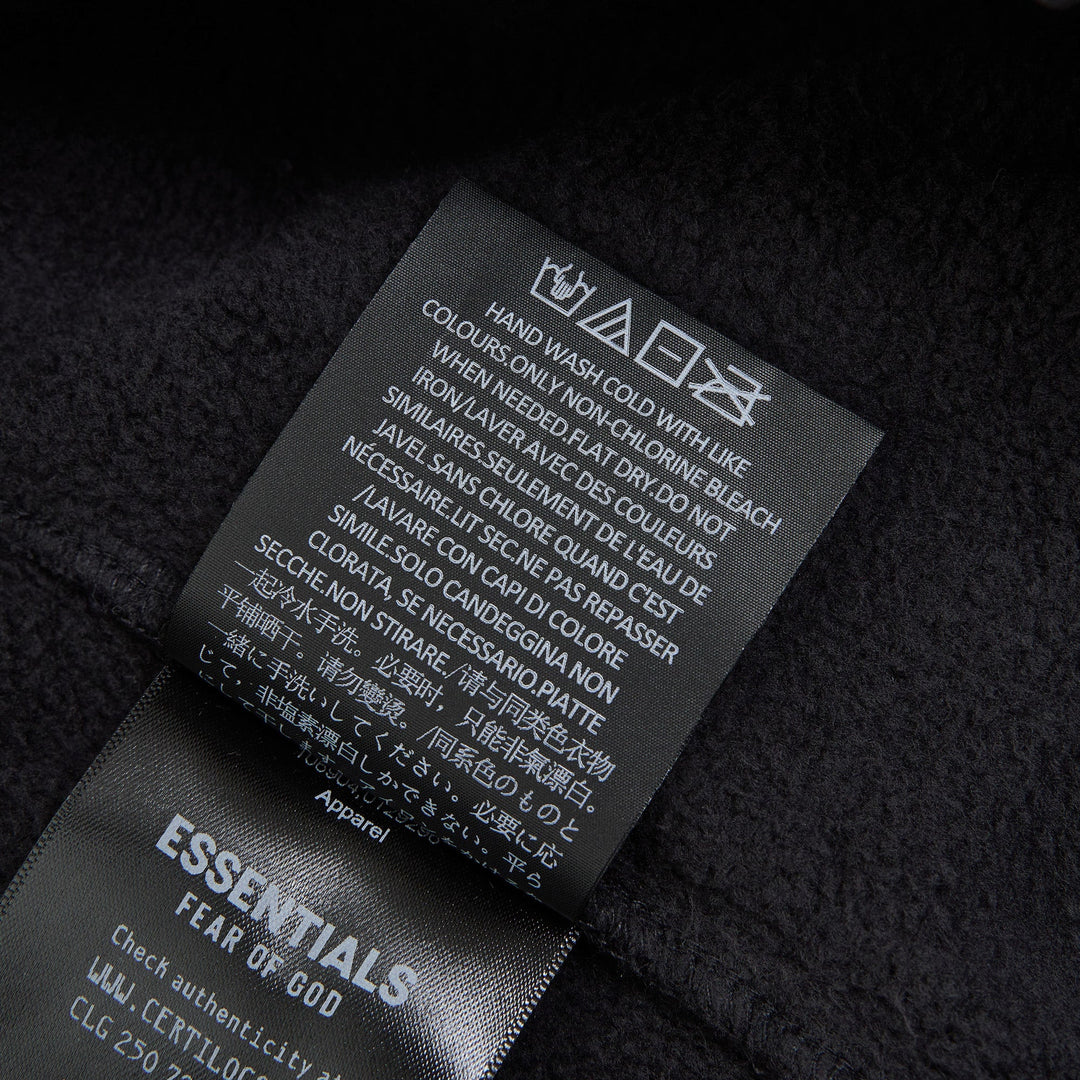 Fear of God Essentials Signature Flare Sweatpant in washed black with elastic drawstring waistband and wide flare leg