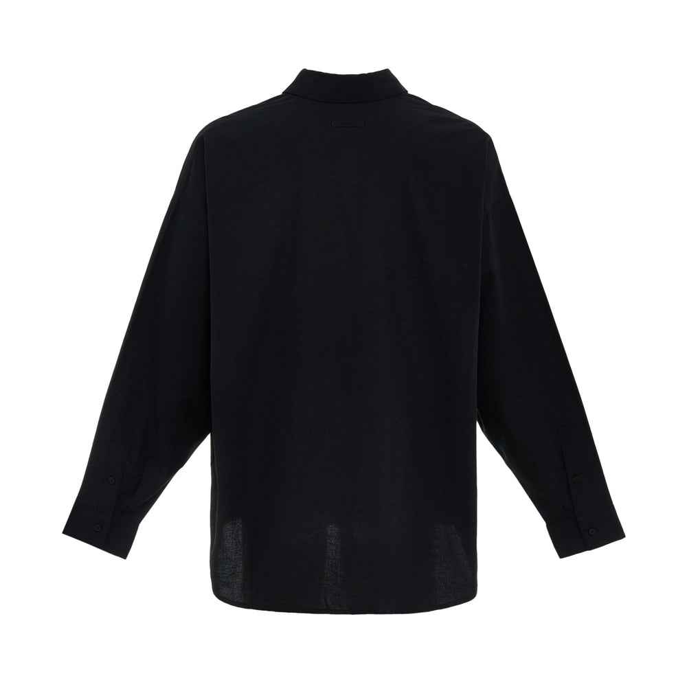Fear of God ESSENTIALS Signature Button-Up Shirt in black with tonal script logo embroidery and relaxed oversized fit, front view