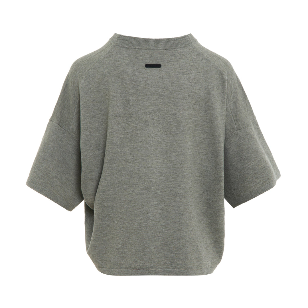 Fear of God ESSENTIALS Women's Boxy Knit Tee in heather grey with wide short sleeves and ribbed mock neckline, flat lay on white background
