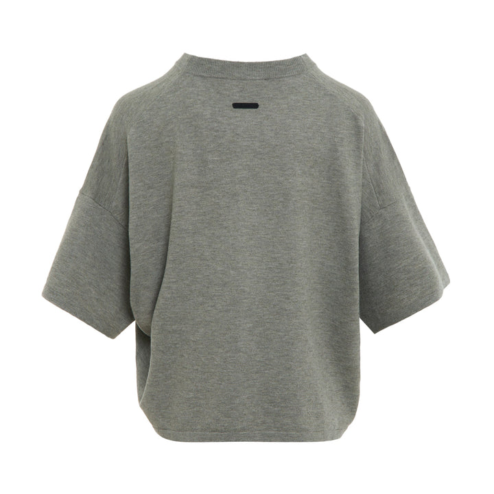 Fear of God ESSENTIALS Women's Boxy Knit Tee in heather grey with wide short sleeves and ribbed mock neckline, flat lay on white background