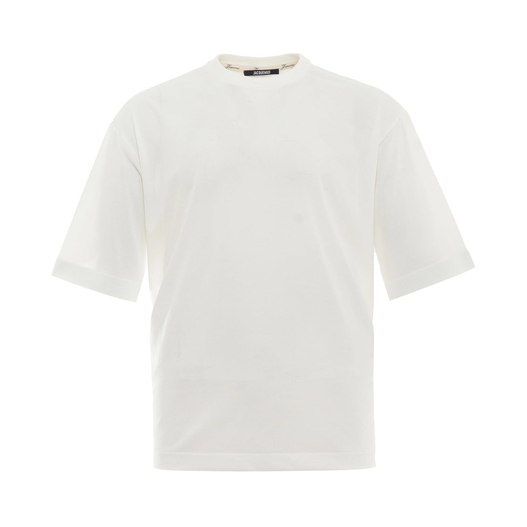 JACQUEMUS Round Square T-Shirt in white with a relaxed boxy fit and crew neckline, displayed on a flat ghost mannequin against a white background.