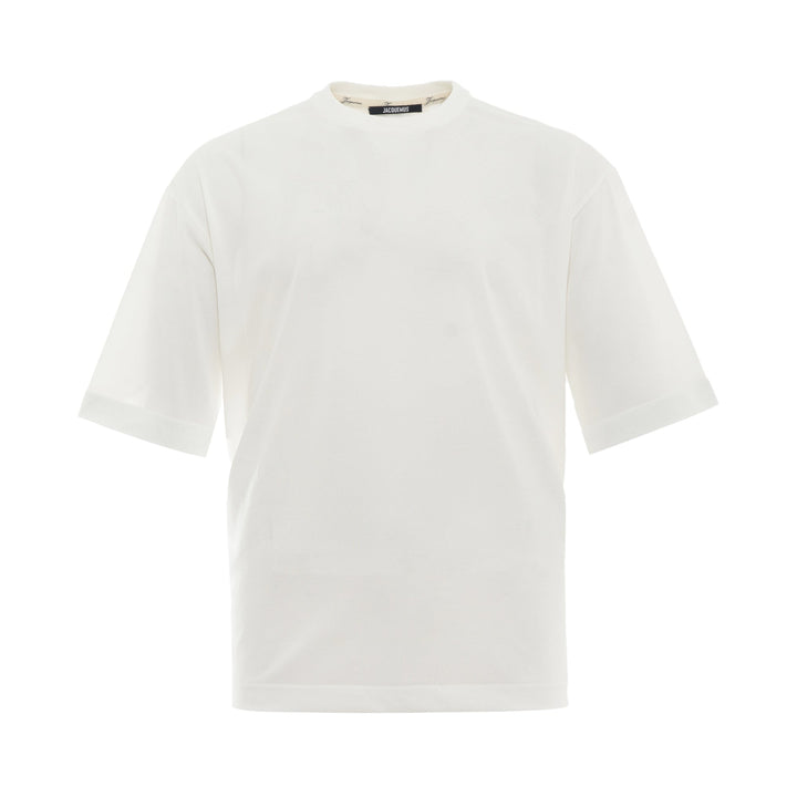 JACQUEMUS Round Square T-Shirt in white with a relaxed boxy fit and crew neckline, displayed on a flat ghost mannequin against a white background.