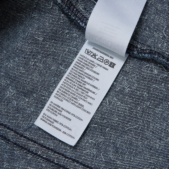Jacquemus dark indigo speckled denim cropped jacket with point collar, chest flap pockets, and button-front closure