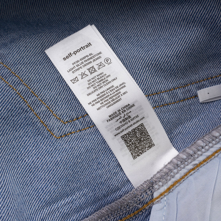 Self-Portrait light blue wide-leg jeans with rhinestone pinstripes and embroidered bow motifs on a white background - view 6