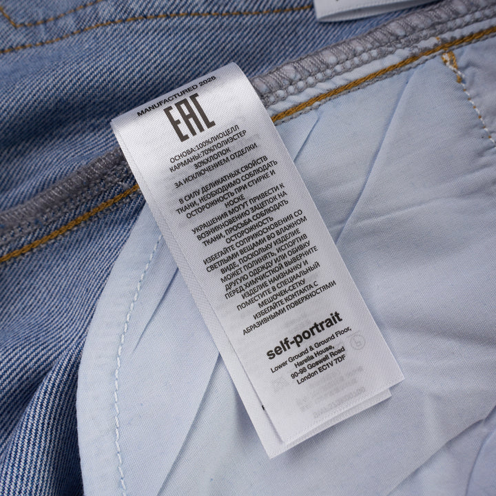 Self-Portrait light blue wide-leg jeans with rhinestone pinstripes and embroidered bow motifs on a white background - view 9