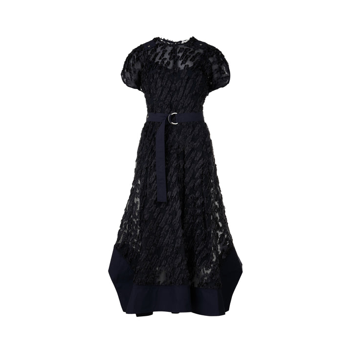 3.1 Phillip Lim black textured organza belted tulip dress with cap sleeves, D-ring navy belt, and contrast navy hem border, photographed on a white background