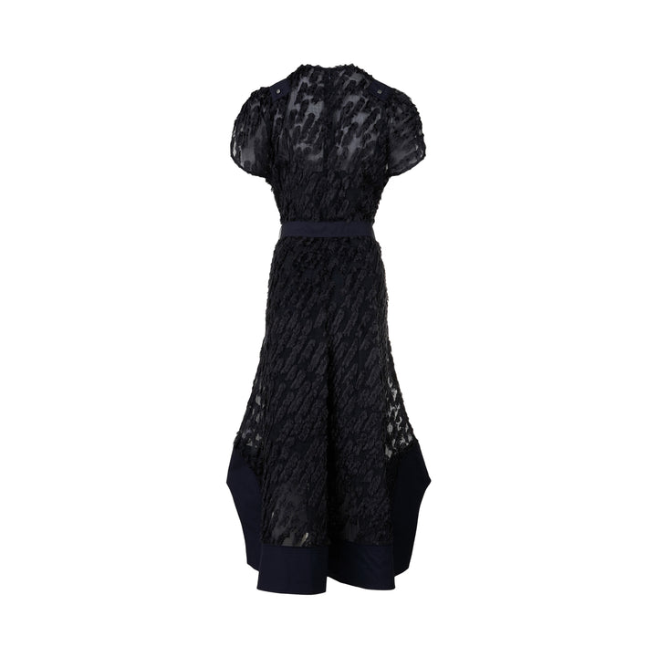 3.1 Phillip Lim black textured organza belted tulip dress with cap sleeves, D-ring navy belt, and contrast navy hem border, photographed on a white background