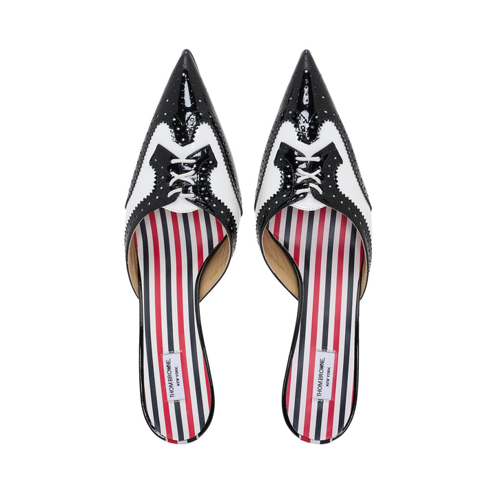 Thom Browne black and white patent leather brogue mule with sculptural flared kitten heel and pointed toe, featuring perforated detailing and signature striped insole lining - view 4