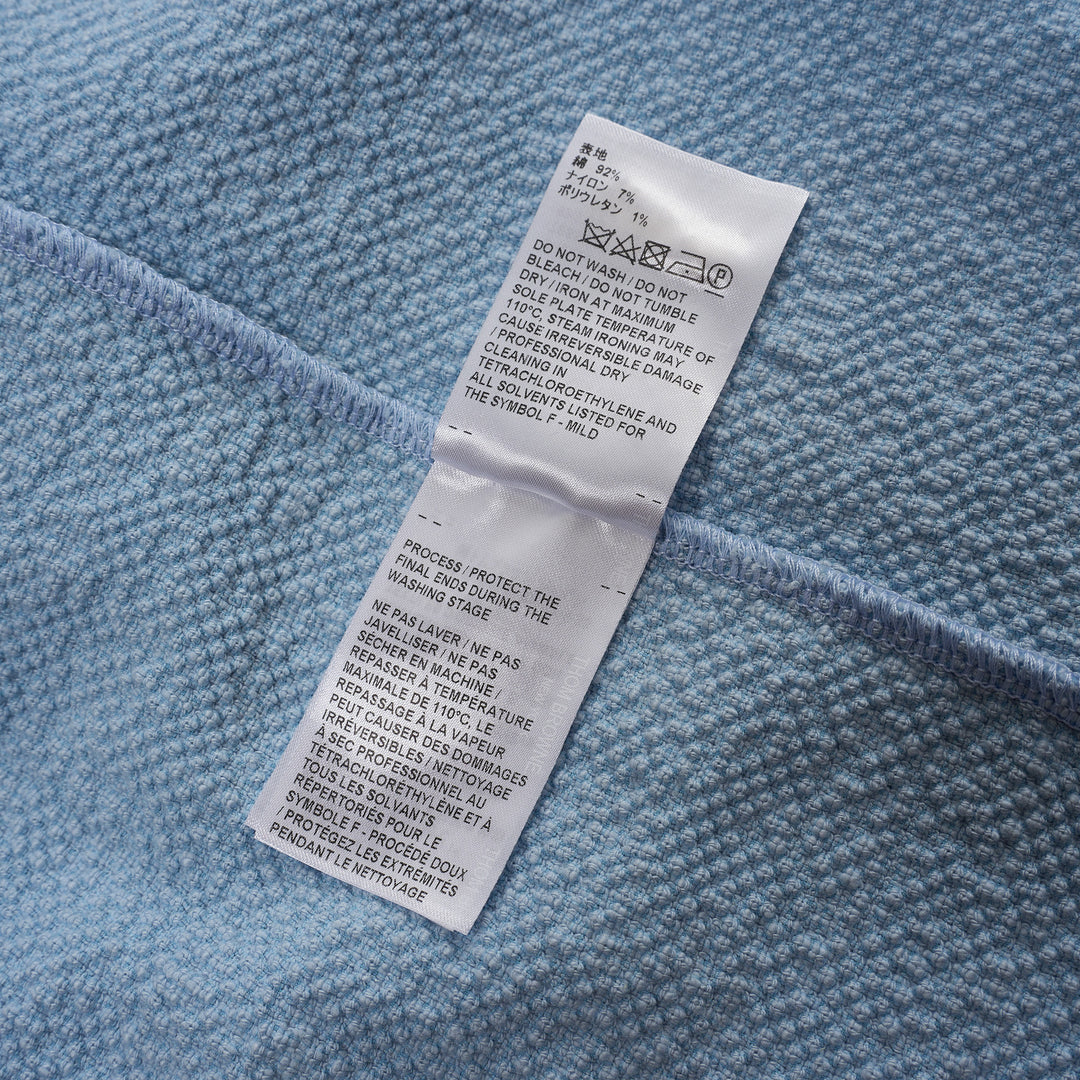 Thom Browne sleeveless polo dress in light blue bouclé with white collar featuring red, white, and blue stripe tipping, button placket, and signature 4-bar stripe at the hem - view 4