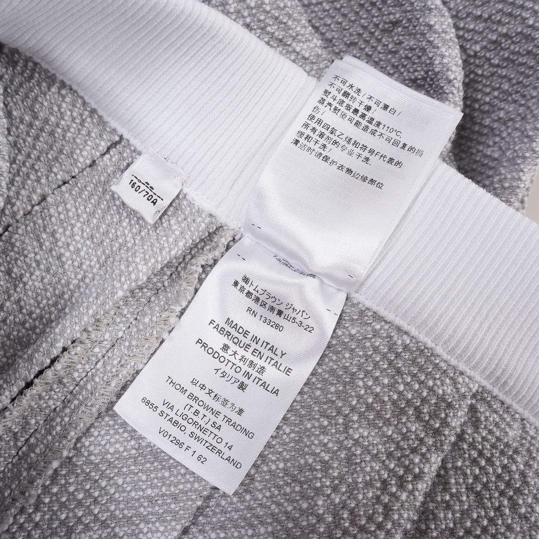 Thom Browne grey piqué pleated mini skirt with red, white, and blue ribbed elasticated waistband and woven brand label at the hem - view 5