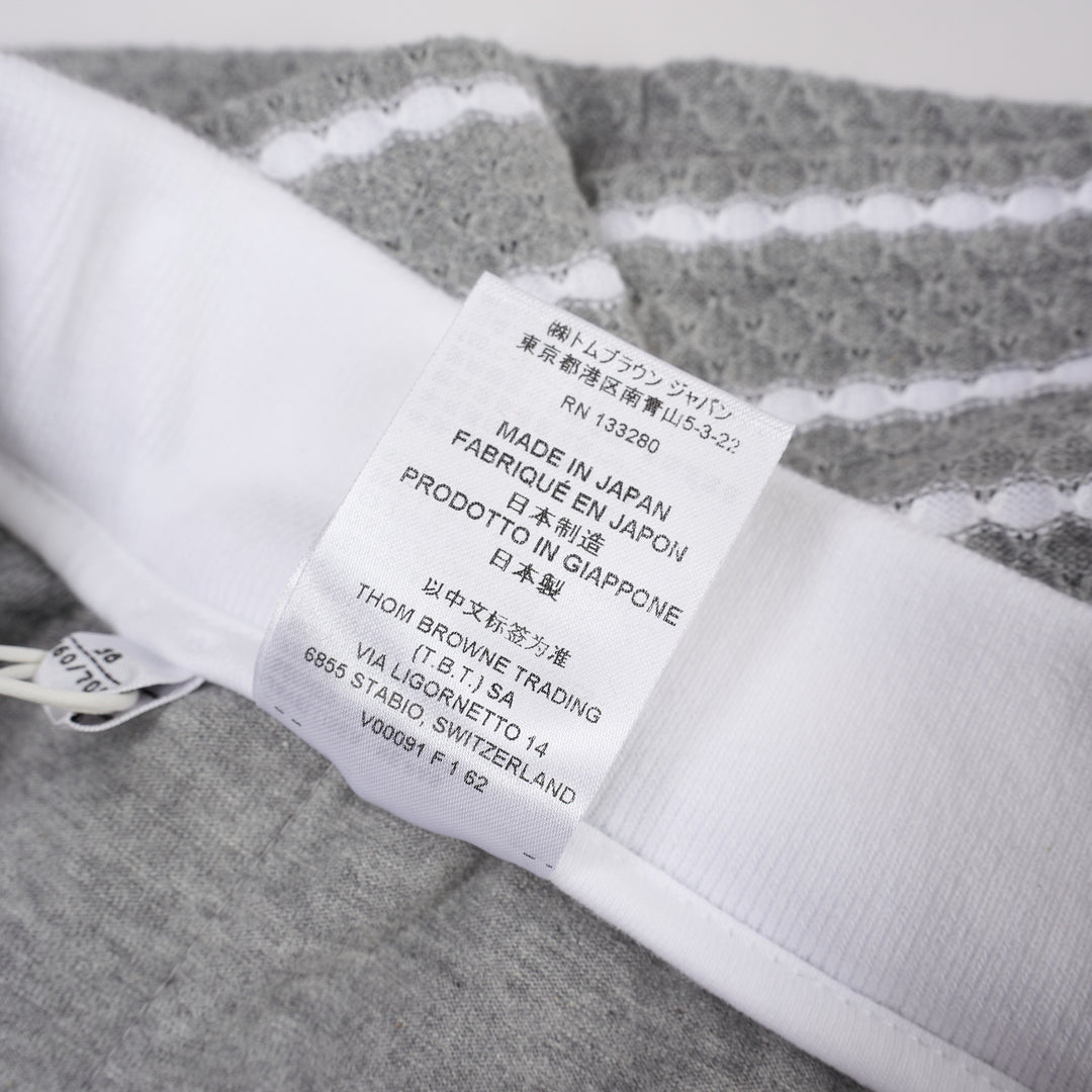 Thom Browne grey and white striped honeycomb-textured knit shorts with white ribbed waistband, drawstring tie with stripe detail, and woven brand label at hem - view 5