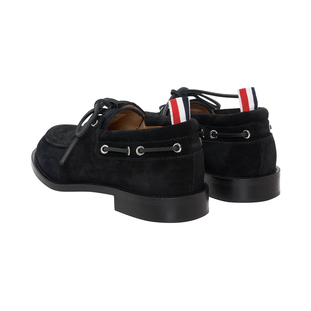 Thom Browne black suede padded boat shoe with moc-toe construction, silver eyelets, leather lacing, and leather outsole, side profile view - view 2