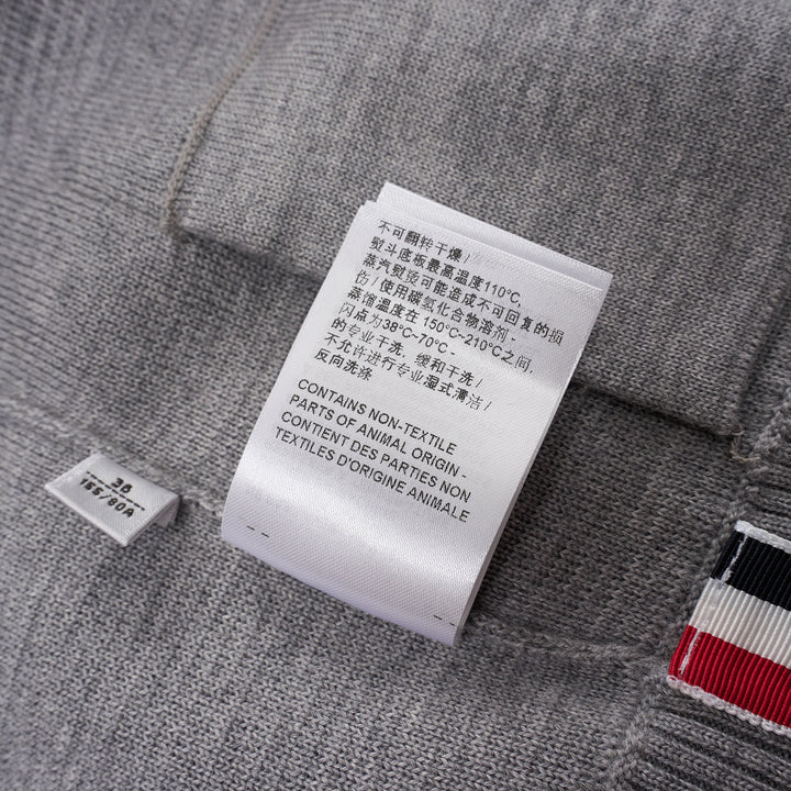 Thom Browne heather grey V-neck cardigan with four-bar white stripe detail on sleeve, button-through front, and ribbed hem and cuffs - view 6