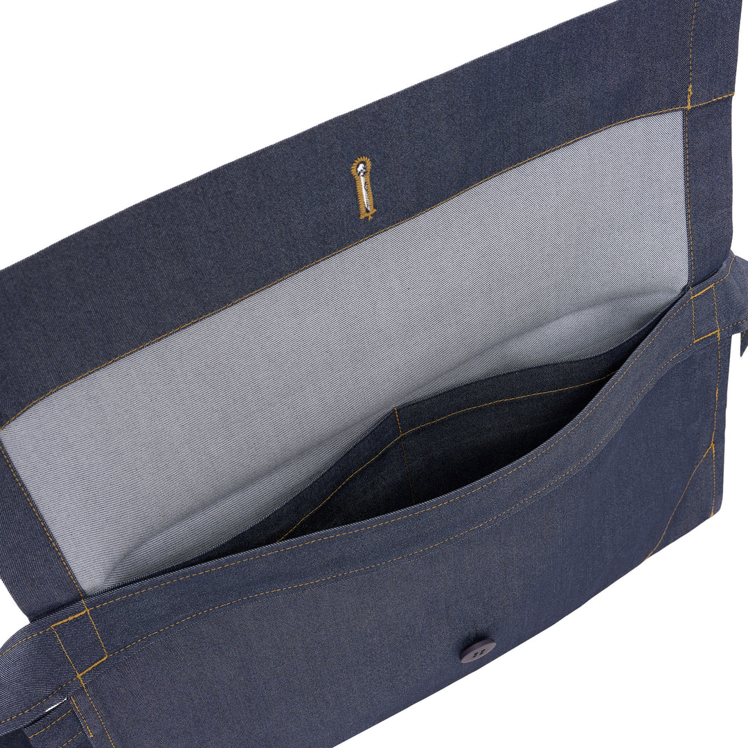 me Issey Miyake Flat Denim Belt Bag in chambray blue with contrast golden stitching, a navy button closure, and an adjustable buckle strap, shown against a white background - view 4