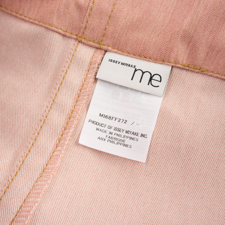 me Issey Miyake Flat Denim Seasonal Pants in dusty rose — wide-leg culotte silhouette with front pleats, utility clip buckle waistband, and cuffed hem, shown flat against a white background - view 3