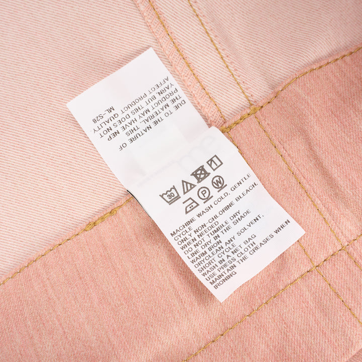 me Issey Miyake Flat Denim Seasonal Pants in dusty rose — wide-leg culotte silhouette with front pleats, utility clip buckle waistband, and cuffed hem, shown flat against a white background - view 4