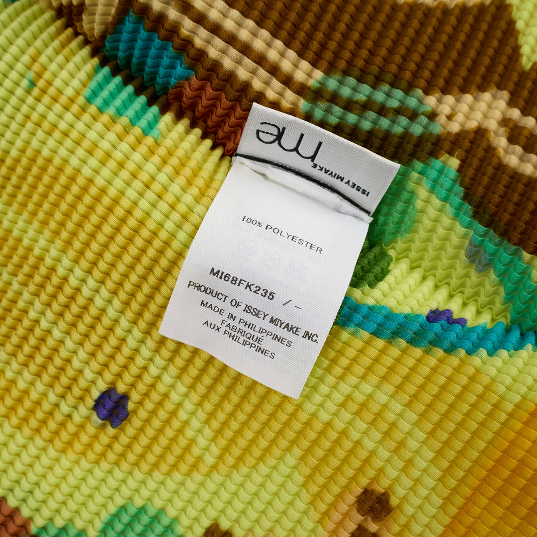 me Issey Miyake Island Print High Neck Top in neon yellow-green with all-over tropical graphic featuring monkeys, palm fronds, and swirling teal brushstrokes in fine-pleat fabric, short cap sleeves, mock-neck collar - view 3