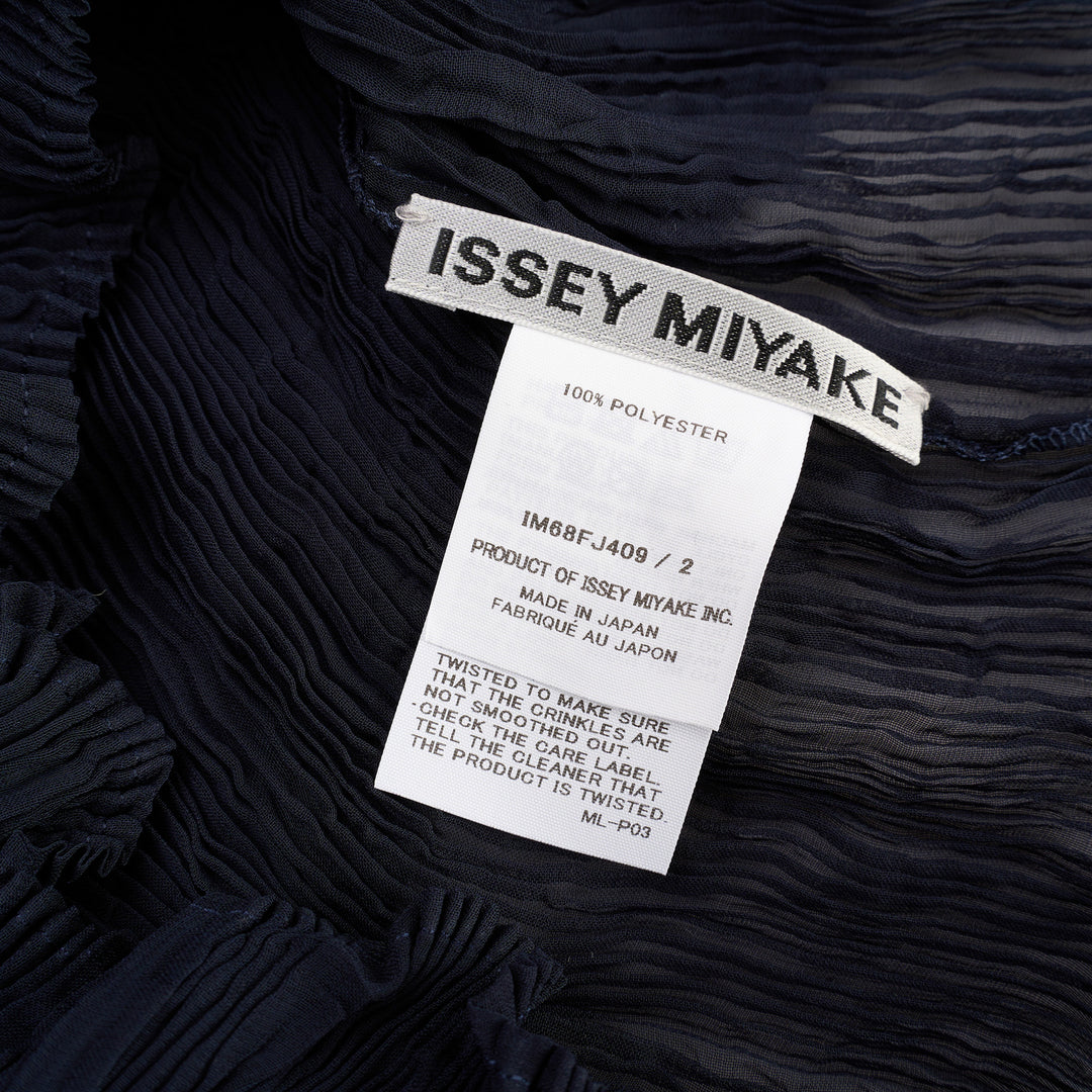 Issey Miyake Chiffon Twist Short Sleeve Shirt in black, featuring sheer pleated fabric and a high mock-neck collar, shown from the back on a mannequin - view 3