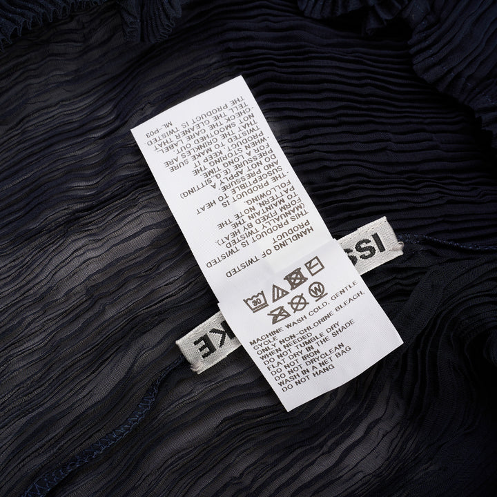 Issey Miyake Chiffon Twist Short Sleeve Shirt in black, featuring sheer pleated fabric and a high mock-neck collar, shown from the back on a mannequin - view 4