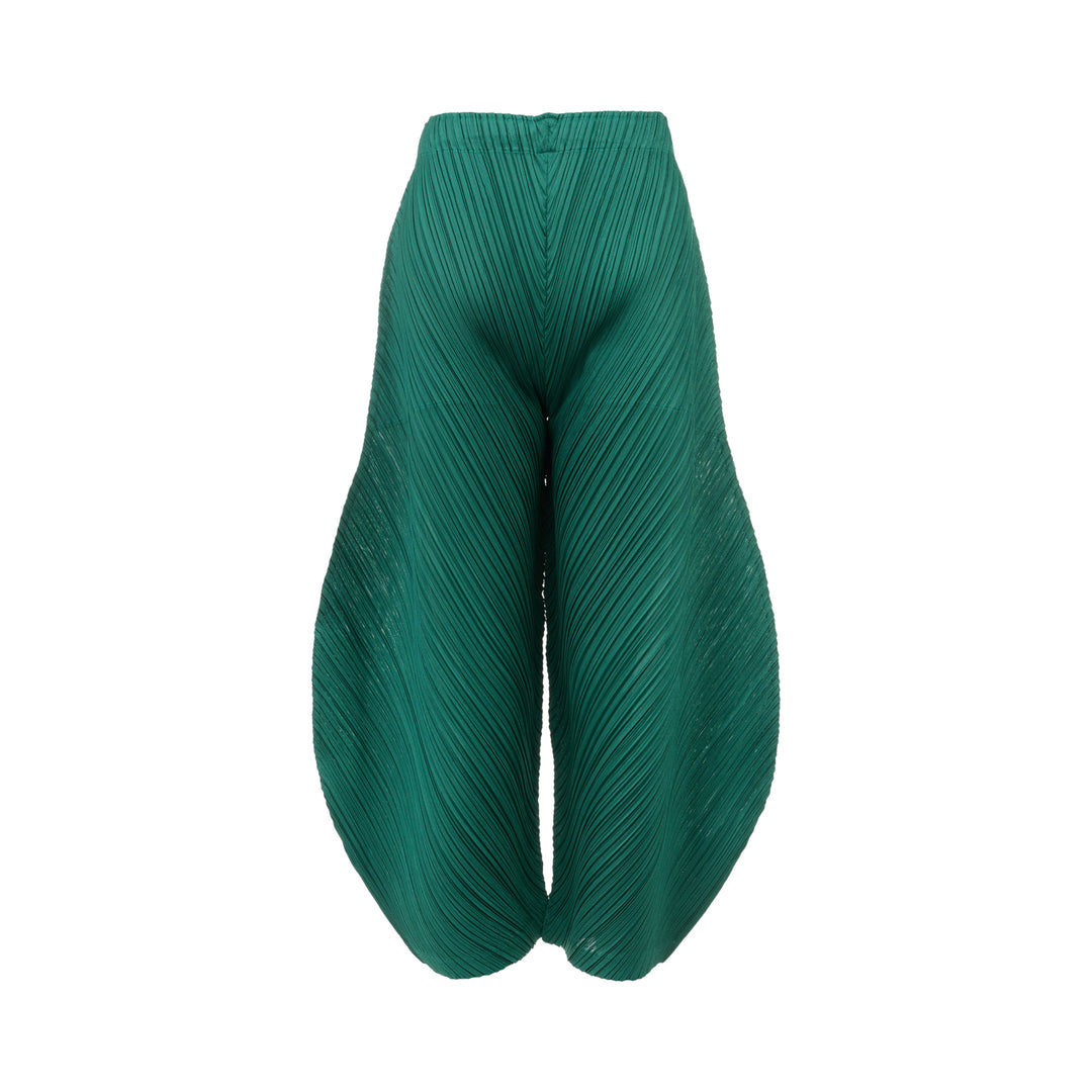 Pleats Please Issey Miyake Thicker Bottoms Pleated Pants in emerald green, displayed flat to show voluminous diagonal-pleated harem silhouette tapering at the ankle