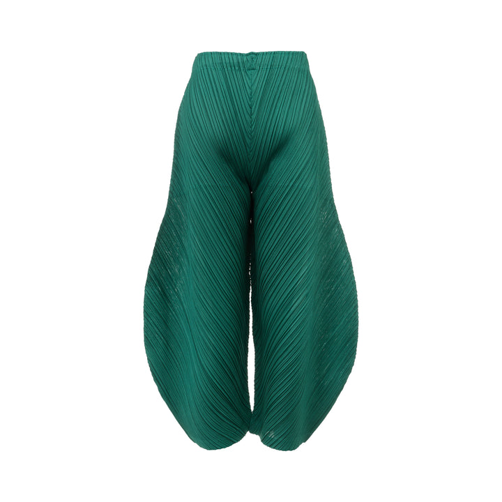 Pleats Please Issey Miyake Thicker Bottoms Pleated Pants in emerald green, displayed flat to show voluminous diagonal-pleated harem silhouette tapering at the ankle