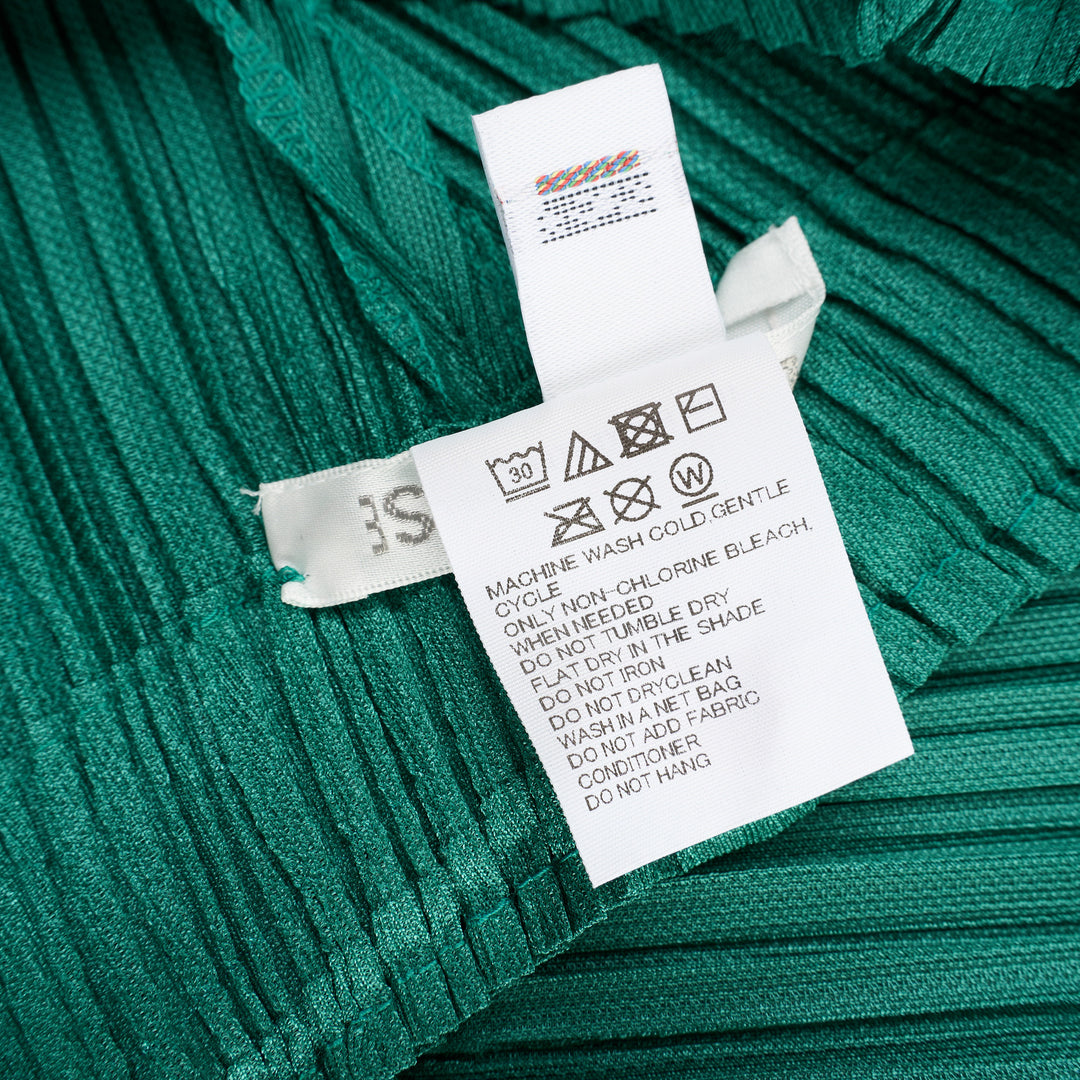 Pleats Please Issey Miyake Thicker Bottoms Pleated Pants in emerald green, displayed flat to show voluminous diagonal-pleated harem silhouette tapering at the ankle - view 4