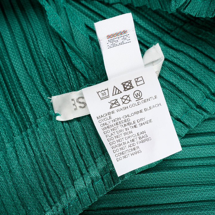 Pleats Please Issey Miyake Thicker Bottoms Pleated Pants in emerald green, displayed flat to show voluminous diagonal-pleated harem silhouette tapering at the ankle - view 4