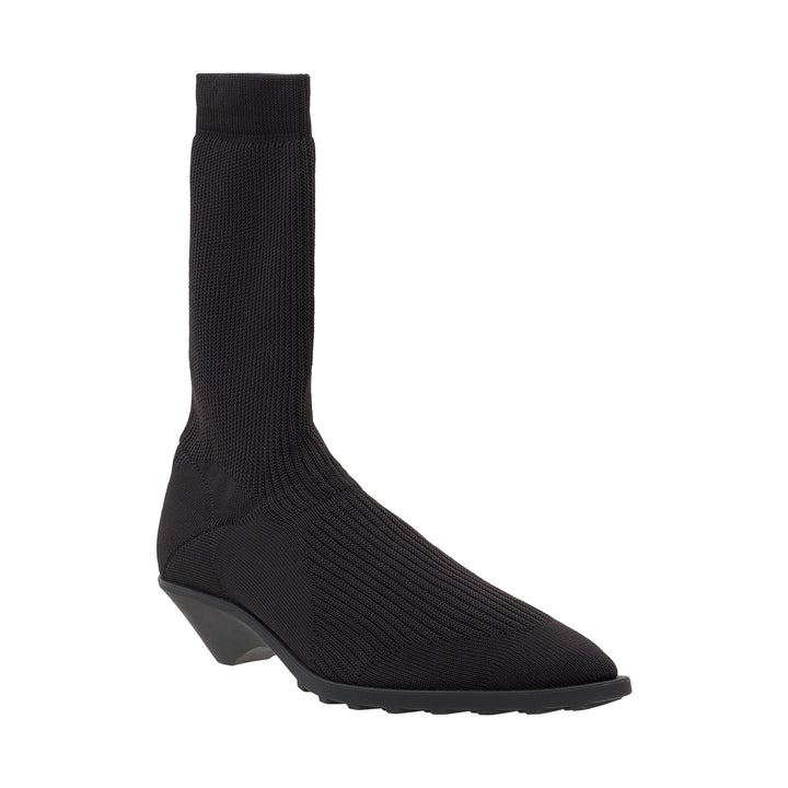 Issey Miyake black fine-gauge ribbed knit sock boot with a pointed toe, star-motif panel at the vamp, and sculptural moulded wedge sole, shown in profile against a white background - view 2