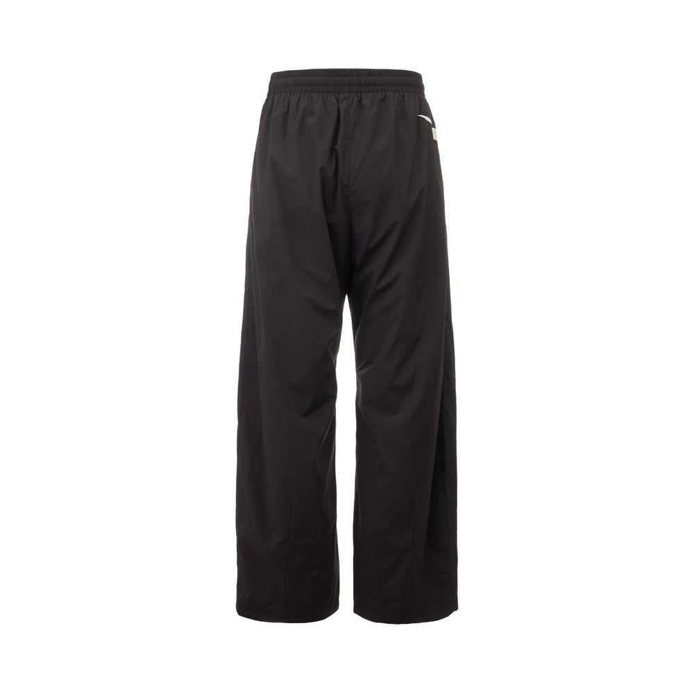 Represent Woven Track Star Pants in black, featuring a wide-leg silhouette, white contrast side panel, elasticated waistband, and embroidered Represent crest badge - view 2