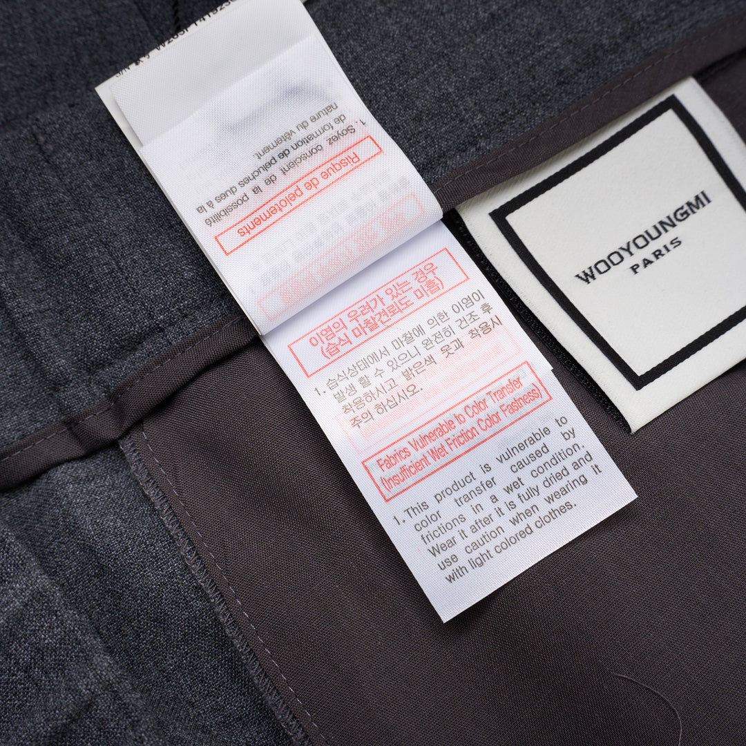 Wooyoungmi Elastic Waist Slim Pants in grey mélange fabric with ribbed knit cuffs and metal hardware detail at the waistband, front view - view 6