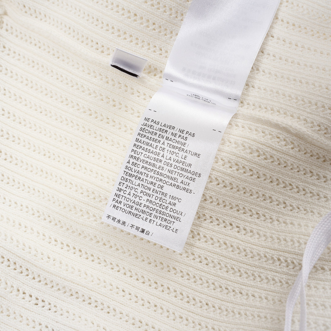 Thom Browne below knee polo dress in ivory ribbed knit with pleated skirt, silver-tone button placket, and signature red, white, and blue stripe cuff trim - view 5